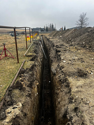 Image 3 - acreage development by Calgary's 2 Sons Excavating, waterline trenching.